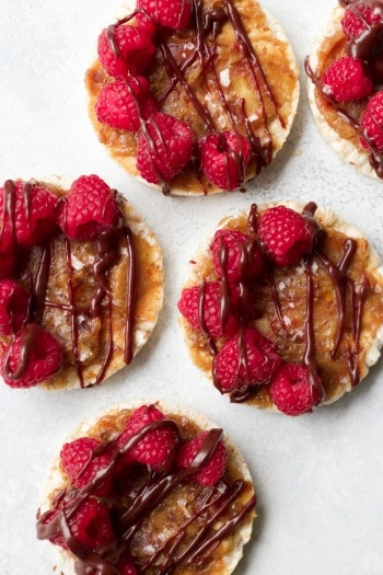Rice cakes topped with Medjool date caramel, fresh raspberries and chocolate drizzle.