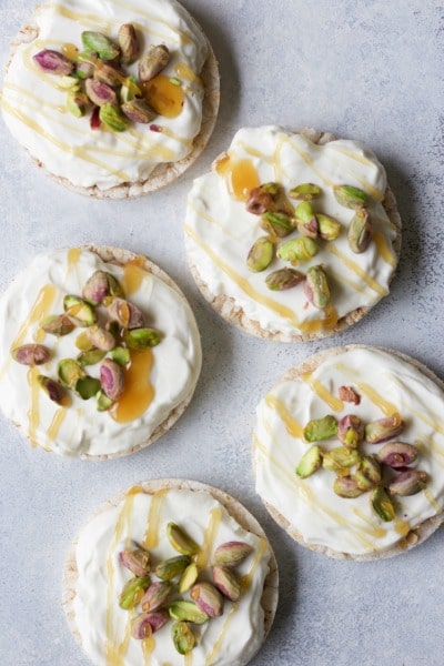 Rice cakes topped with cream cheese, pistachios and honey.