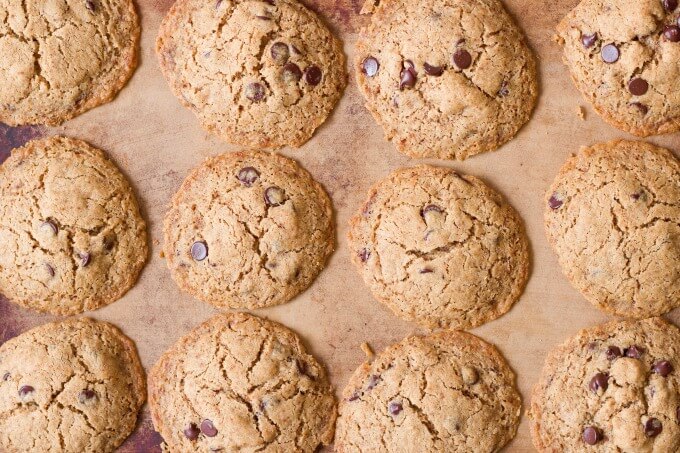 Chocolate chip cookies on a stoneware baking sheet.