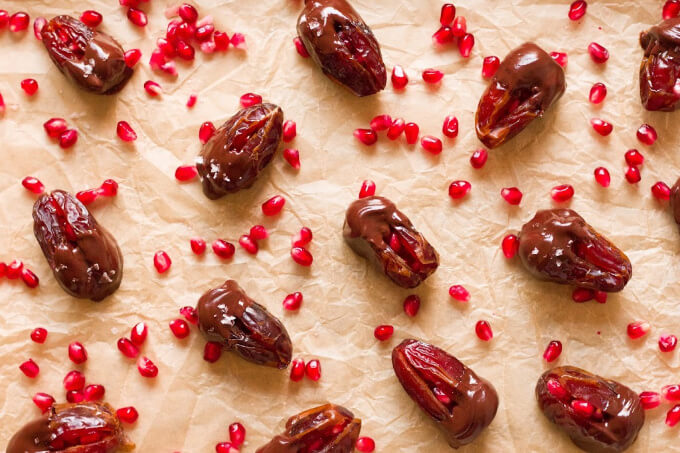 Chocolate dipped dates with pomegranate arils.