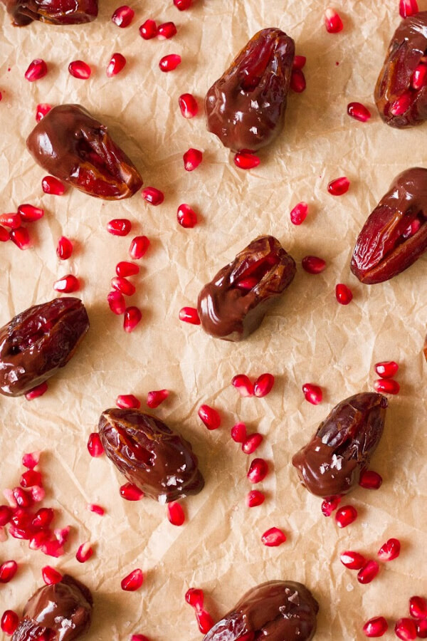 Chocolate dipped dates with pomegranate arils.